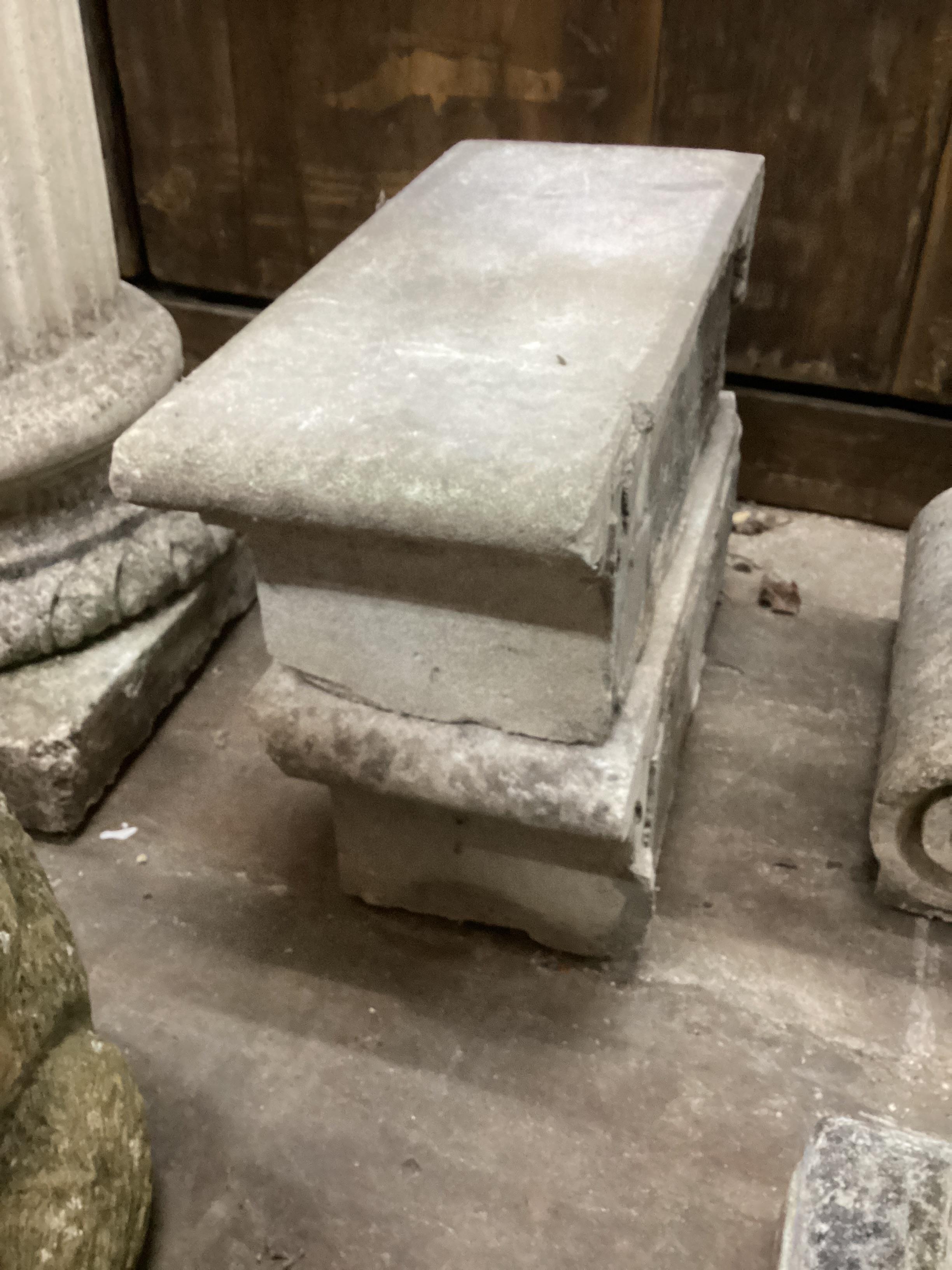 Three reconstituted stone garden plinths, largest width 40cm, height 50cm